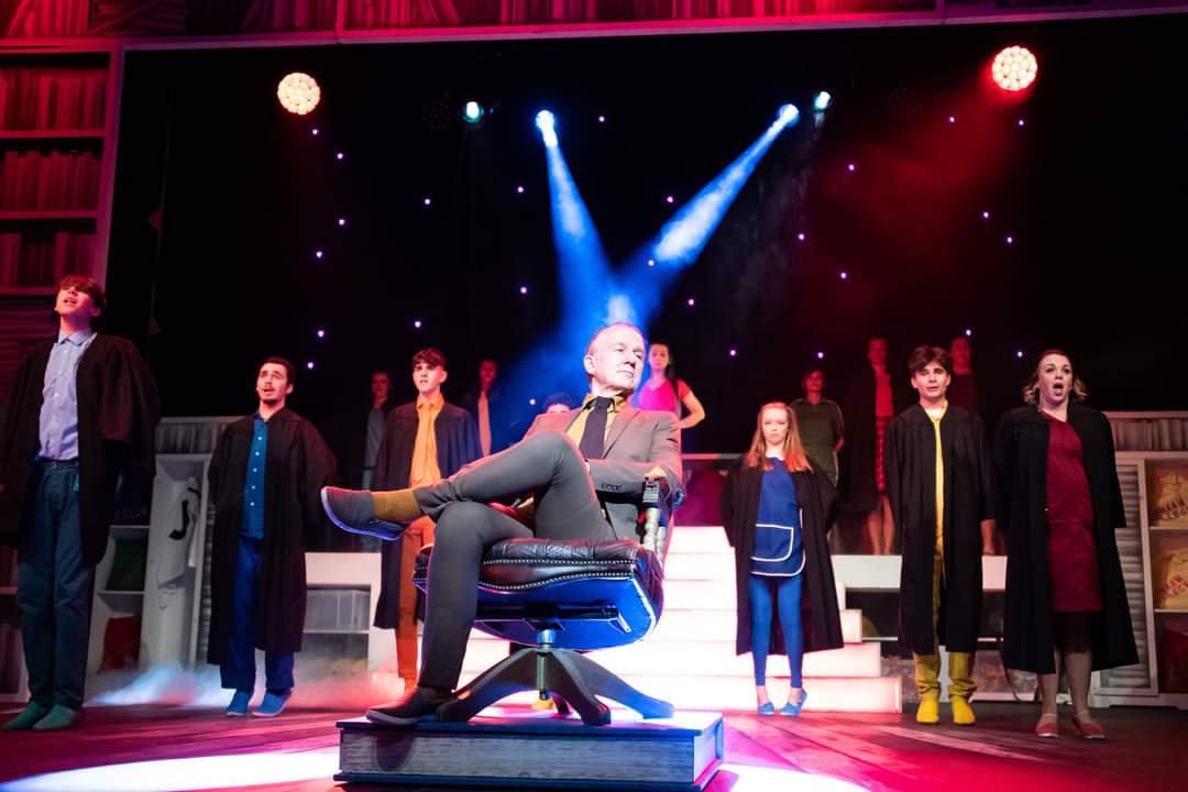 Production still — stage wash and silhouette
